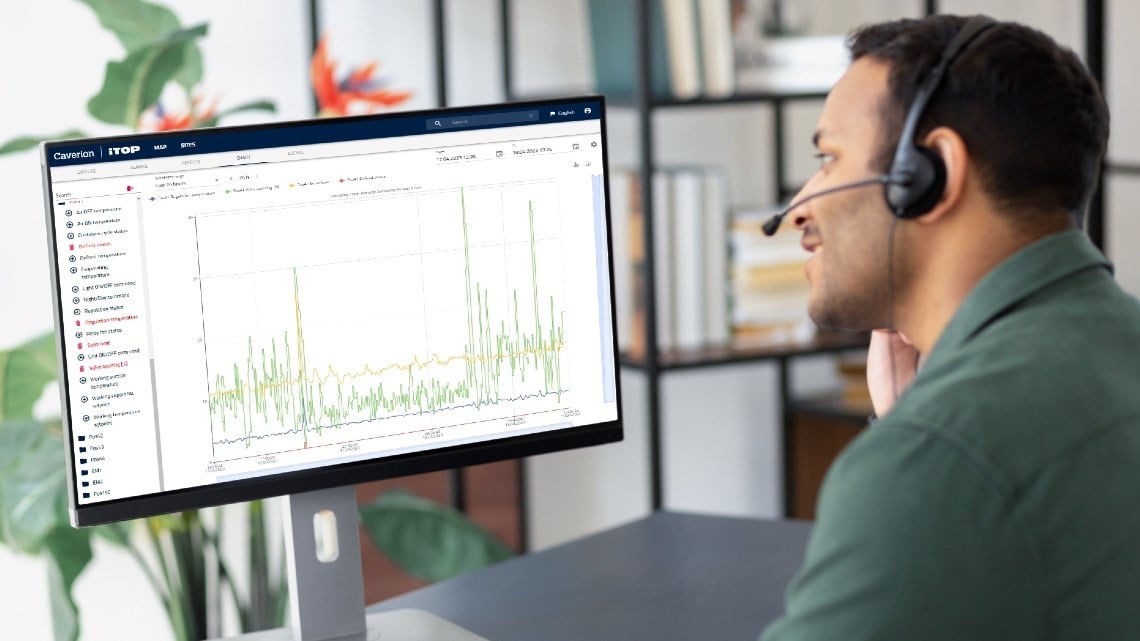 Man with headset looking at a monitor